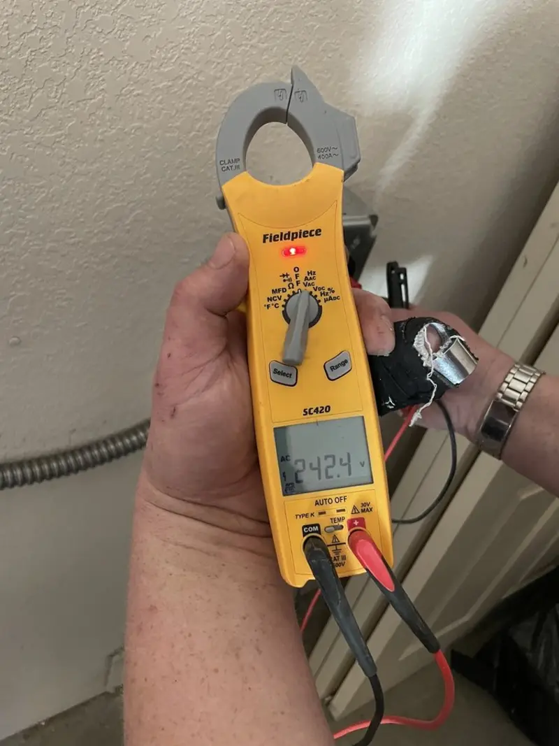 Voltage testing with clamp meter during Electrical Installation Services in Welch